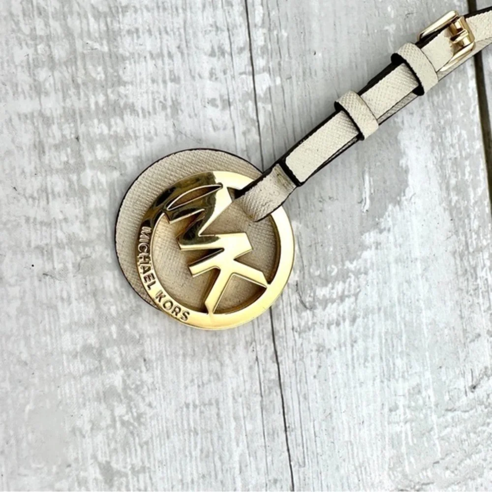 Michael Kors handbag charm.